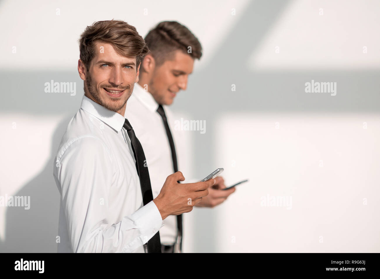 Businessmans holding mobile phone Stock Photo