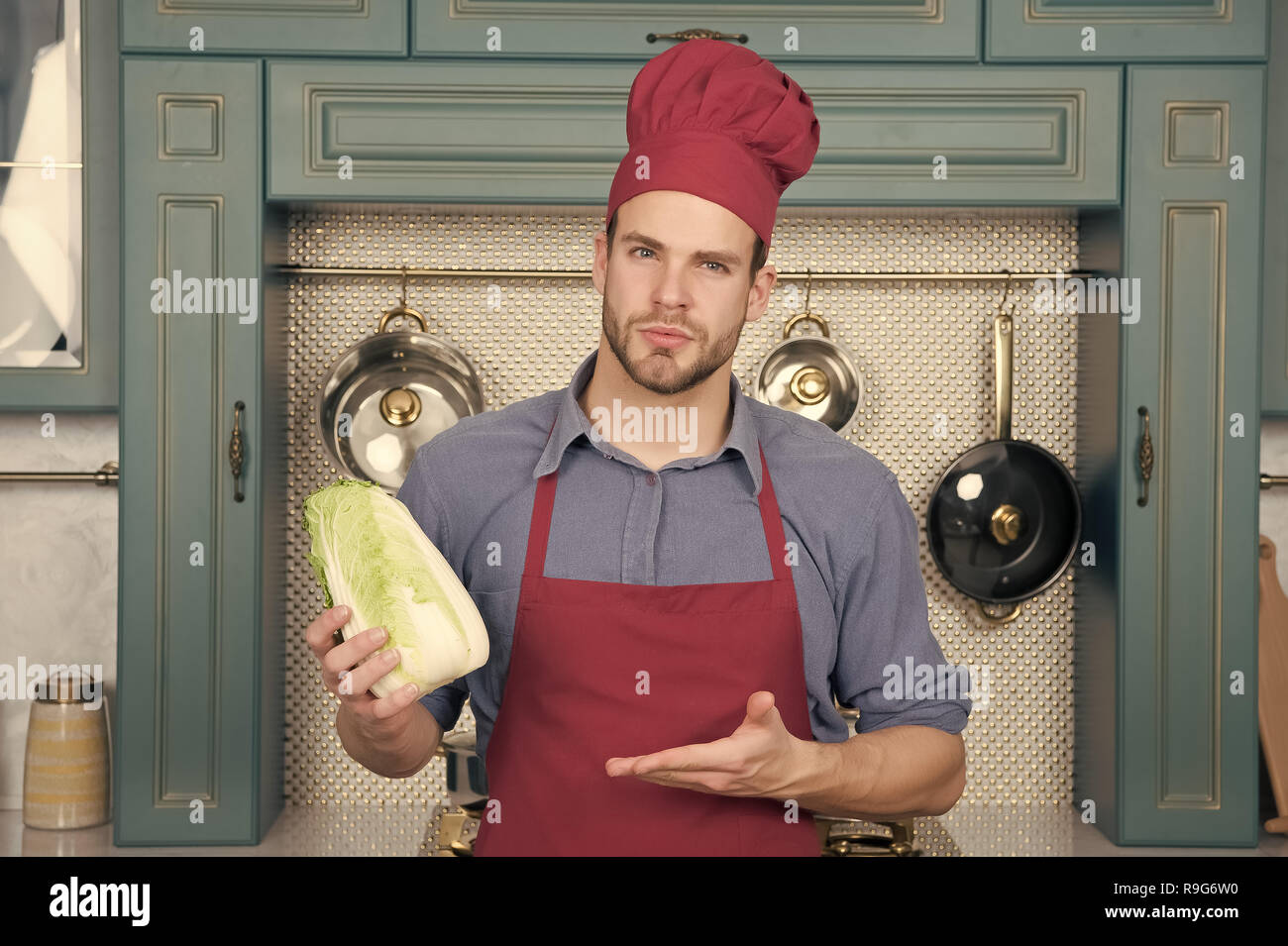Cook Man Point Hand At Chinese Cabbage Chef In Red Hat Apron