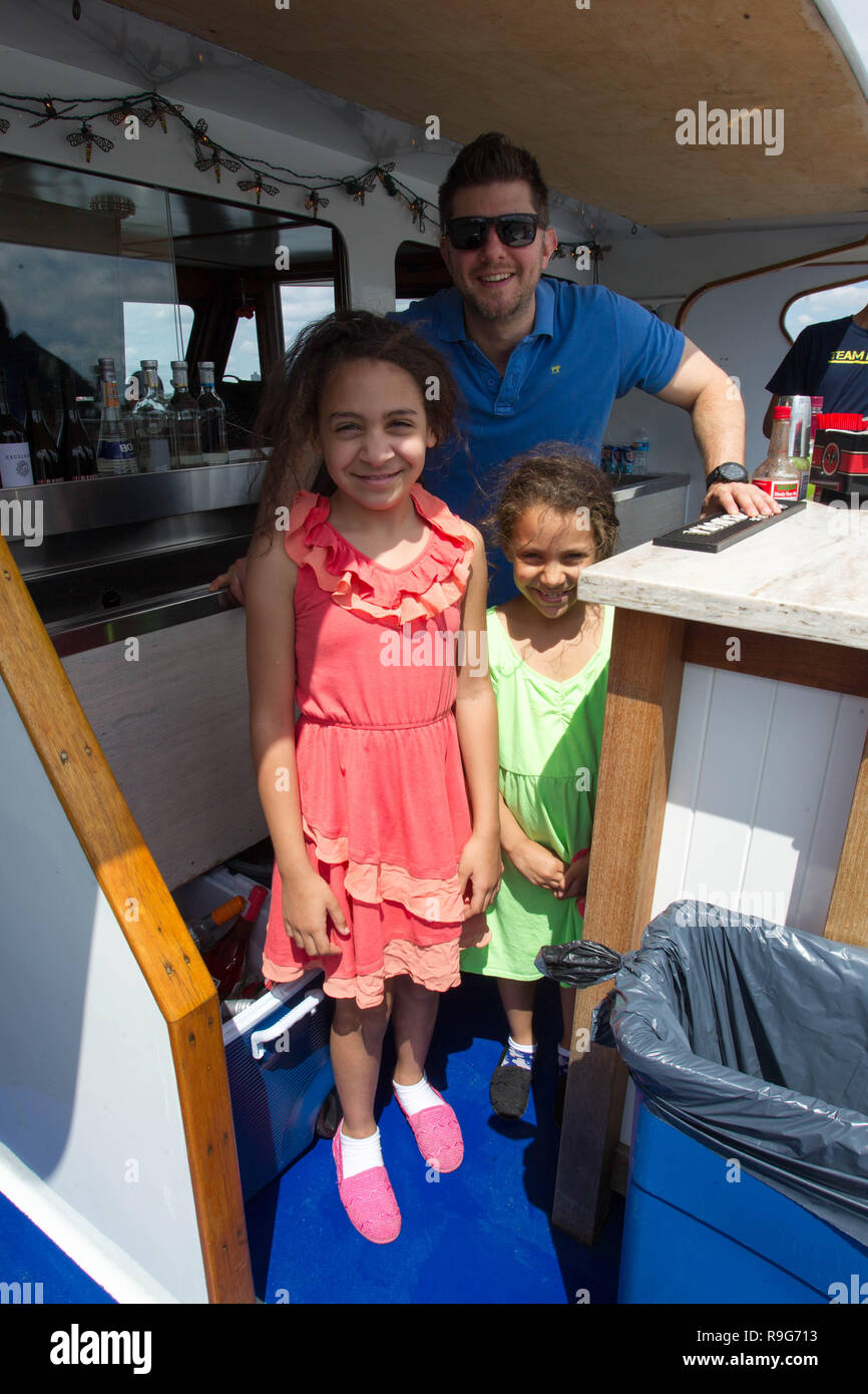 NEW YORK, NY - JUNE 21:  Children pose on the bridge with a crew member of The 2015 Father's Day Cruise on New York Health and Racquet Yacht on June 21, 2015 in New York City. (Photo by Steve Mack/S.D. Mack Pictures) Stock Photo