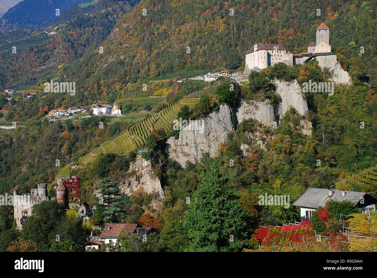 Panorama view on valleys and mountains in the italian alps, nearby Meran, South Tyrol, Italy. On the right the Castle Tyrol, on the left the Brunnenbu Stock Photo