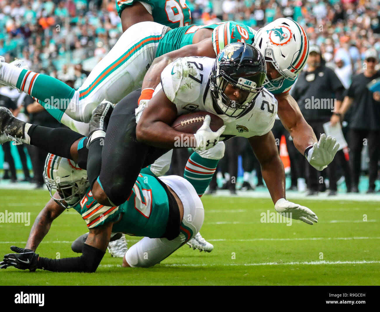 Miami Gardens, Florida, USA. 23rd Dec, 2018. Miami Dolphins defensive end Robert Quinn (94) tackles Jacksonville Jaguars running back Leonard Fournette (27) before reaching the end zone during an NFL game at the Hard Rock Stadium in Miami Gardens, Florida. The Jaguars won 17-7. Credit: Mario Houben/ZUMA Wire/Alamy Live News Stock Photo