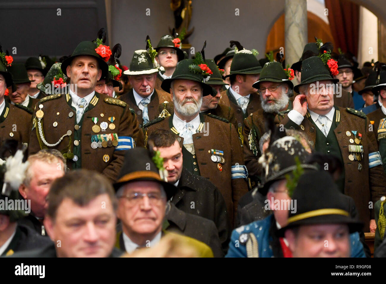 Waakirchen, Germany. 24th Dec, 2018. Mountain marksmen take part in a memorial service for the victims of the 'Sendlinger Mordweihnacht' in the church in Waakirchen (Bavaria). With a memorial service and a laying of a wreath, the participants commemorate the revolt of the Bavarian population against the Habsburg occupation, which was bloodily suppressed on Christmas Day 1705. Credit: Tobias Hase/dpa/Alamy Live News Stock Photo