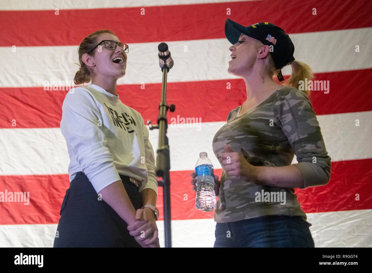 Country Music Singer Kellie Pickler, right, performs with a sailor during the Joint Chiefs USO Christmas Show for deployed service members aboard the aircraft carrier USS John C. Stennis  December 23, 2018 in the Persian Gulf. This year’s entertainers include actors Milo Ventimiglia, Wilmer Valderrama, DJ J Dayz, Fittest Man on Earth Matt Fraser, 3-time Olympic Gold Medalist Shaun White, Country Music Singer Kellie Pickler, and comedian Jessiemae Peluso. Stock Photo