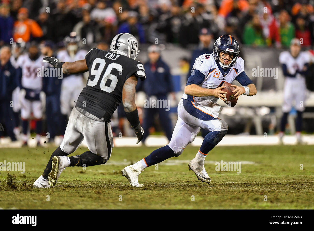 Oakland, CA. 24th Dec, 2018. Oakland Raiders defensive end Kony Ealy (96) chases Denver Broncos quarterback Case Keenum (4) during the NFL football game between the Denver Broncos and the Oakland Raiders at the Oakland Alameda Coliseum in Oakland, CA. Chris Brown/CSM/Alamy Live News Stock Photo