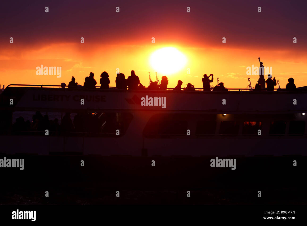 New York, NEW YORK, USA. 24th Dec, 2018. Sunset is seen from the Battery Park on Manhattan Island in New York in the United States on the afternoon of this Monday, 24. From the spot to spot the Statue of Liberty. Credit: William Volcov/ZUMA Wire/Alamy Live News Stock Photo