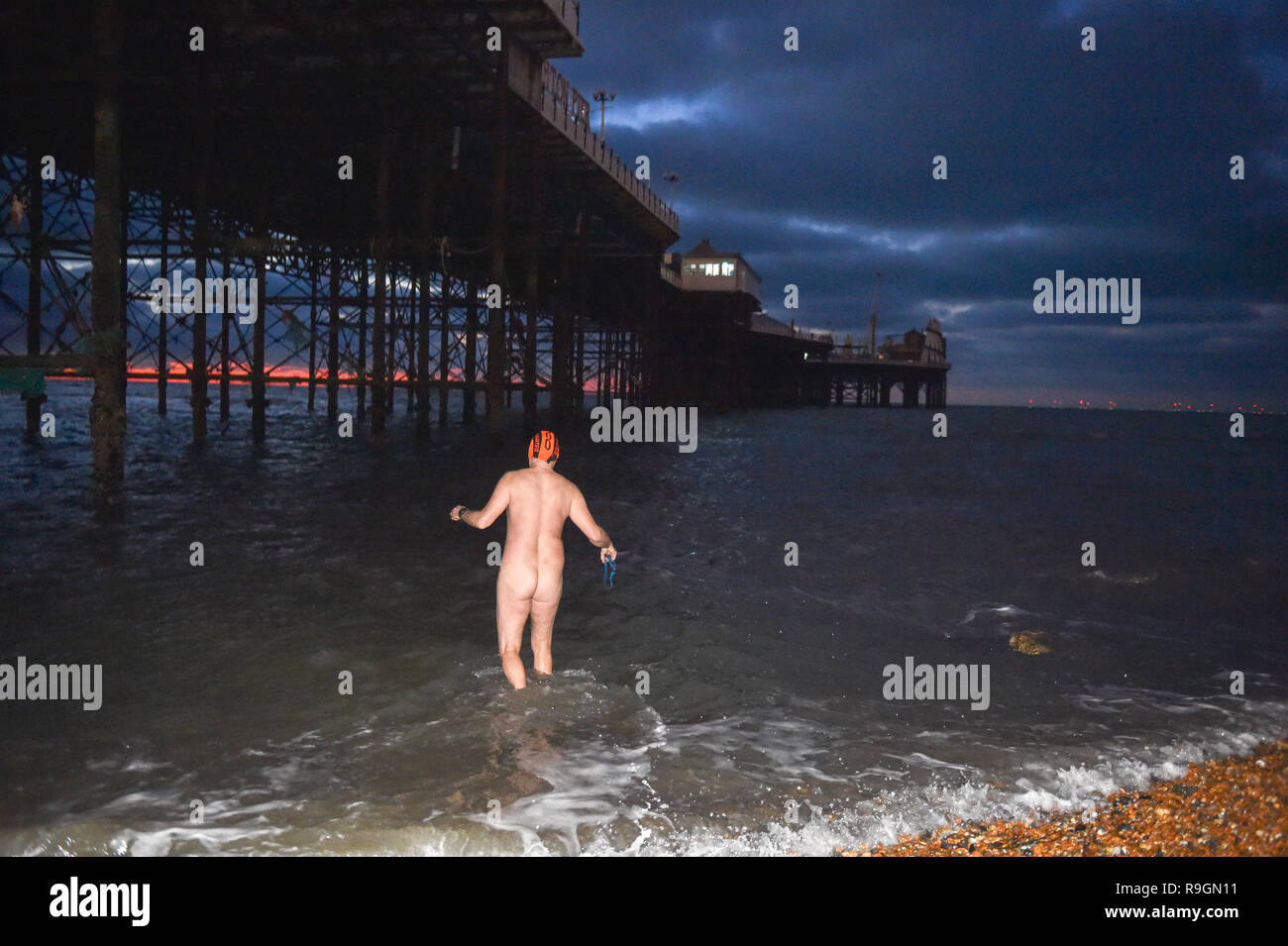 Brighton, UK. 25th Dec, 2018. This member of Brighton Swimming Club enjoys  an early Christmas morning skinny dip in the sea at sunrise . They are  Britains oldest swimming club, founded in