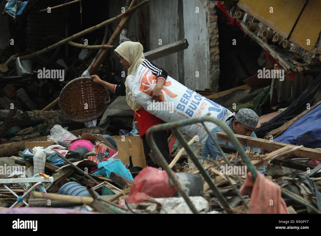 South Lampung, Lampung, Indonesia. 25th Dec, 2018. LAMPUNG, INDONESIA - DECEMBER 25 : People searching something at his house after the tsunami hit at South Lampung on Decemebr 25, 2018 in Pandegralang regency, Banten Province, Indonesia.A tsunami struck Indonesia's Sunda Strait, the expanse between the islands of Java and Sumatra, on the night of December 22, local time. Credit: ZUMA Press, Inc./Alamy Live News Stock Photo