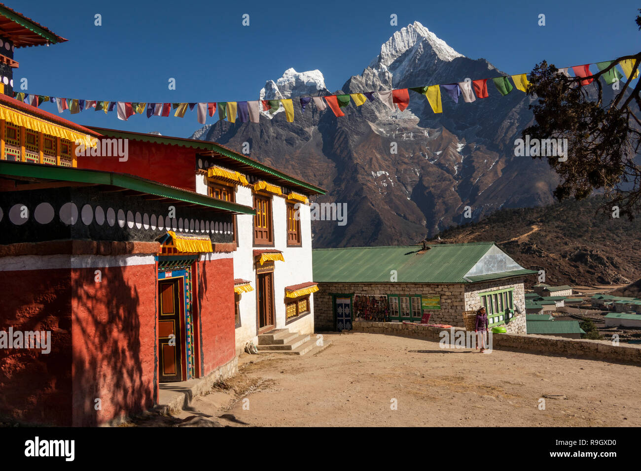 Nepal, Everest Base Camp Trek, Khumjung, traditional village gompa with view of Hongku snow capped peak Stock Photo