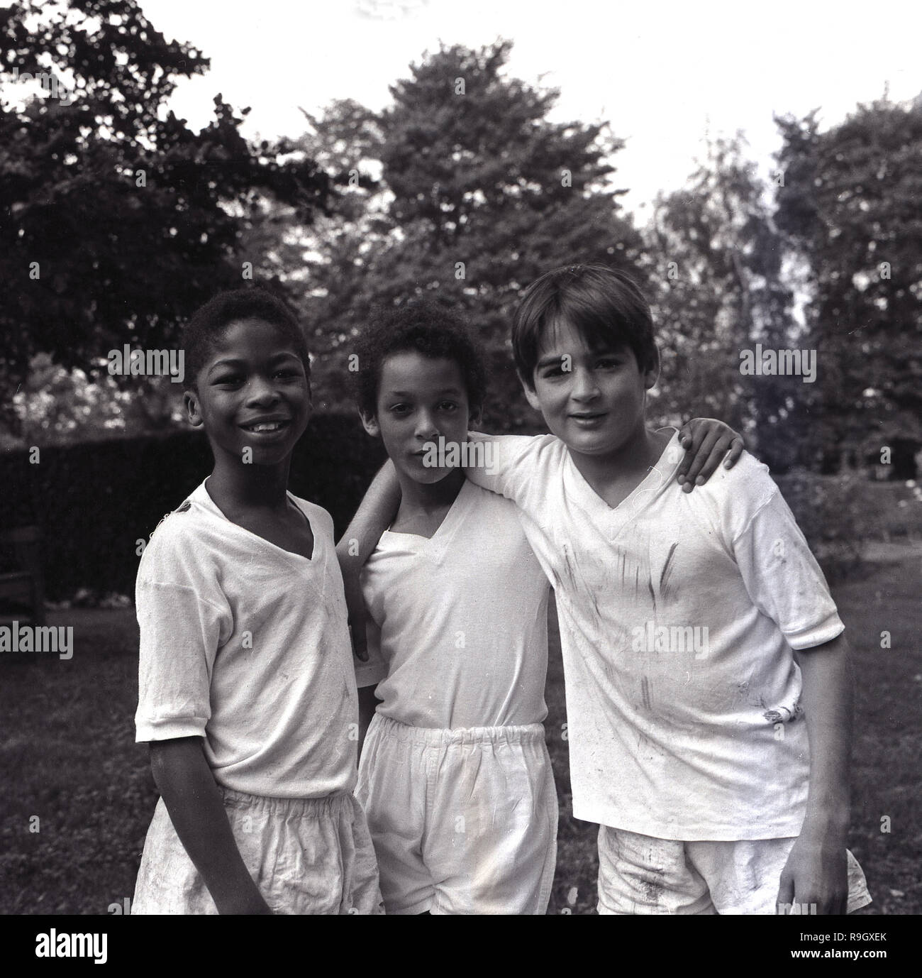 1968, at a south london boys boarding school, England, three schoolboys outside in their PE kit, England, UK. Stock Photo
