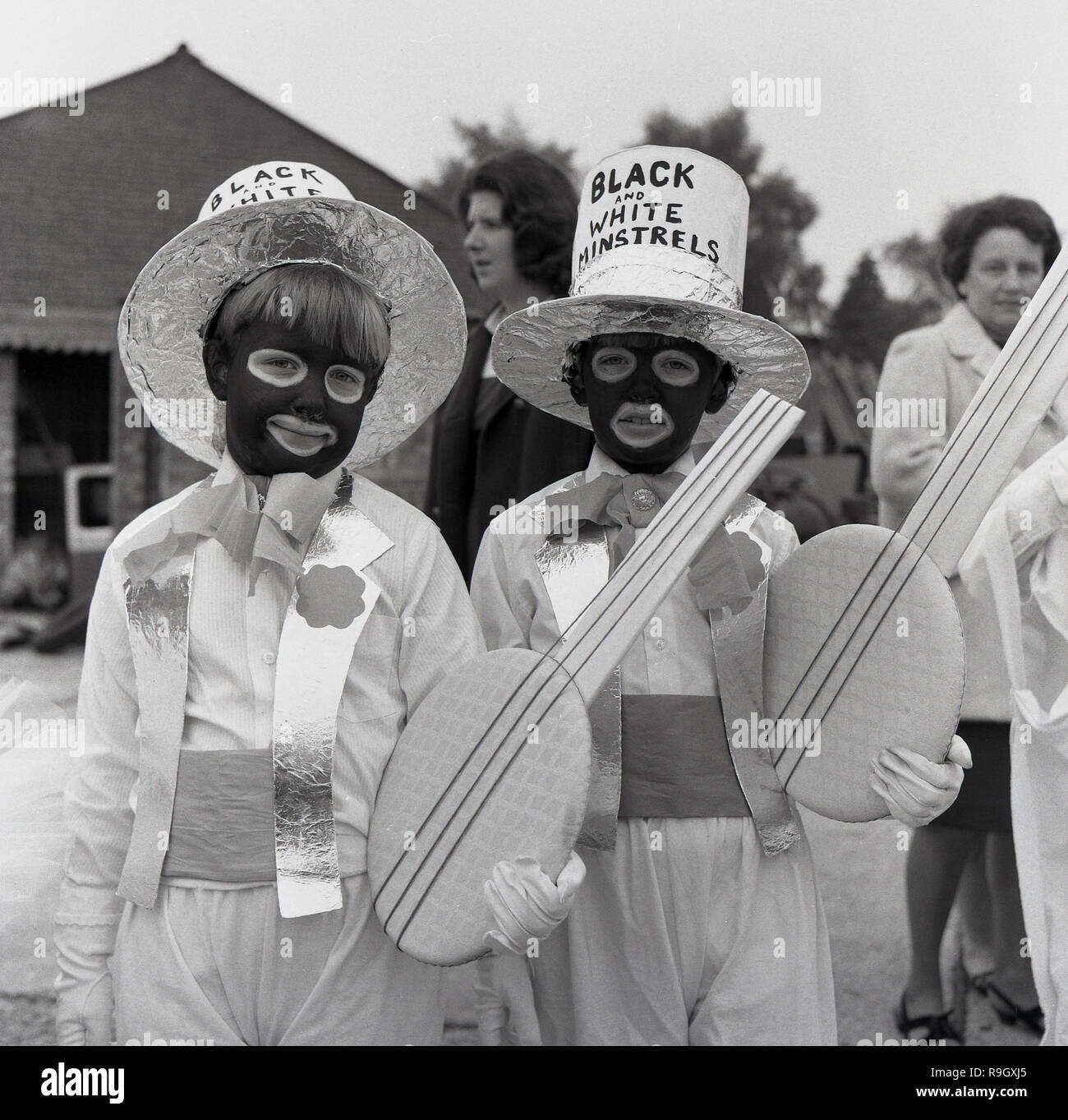 1960s, at the Prestwood village fete, two young boys wearing fancy dress costumes based on characters from the 'Black and White Minstrel Show, a popular British light entertainmen show that ran on BBC television for twenty years from 1958. The male minstrels appeared in 'blackface', the female dancers and other supporting artists did not. Such was its popularity that in 1964, the programme was seen by 21 million viewers and the theatrical show at the Victoria Palace theatre based on the show entered the Guinness Book of Records as the stage show seen by the largest number of people. Stock Photo