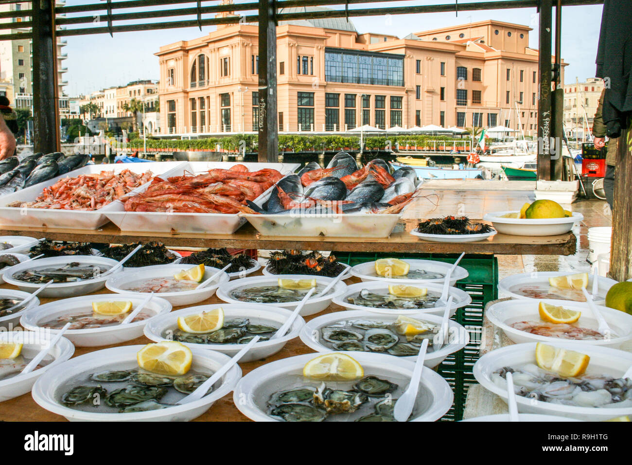 Open air street food fish market on Bari promenade with raw fresh sushi ready to eat: shrimp, oyster, sea urchin, cuttlefish, squid, octopus and salpa Stock Photo