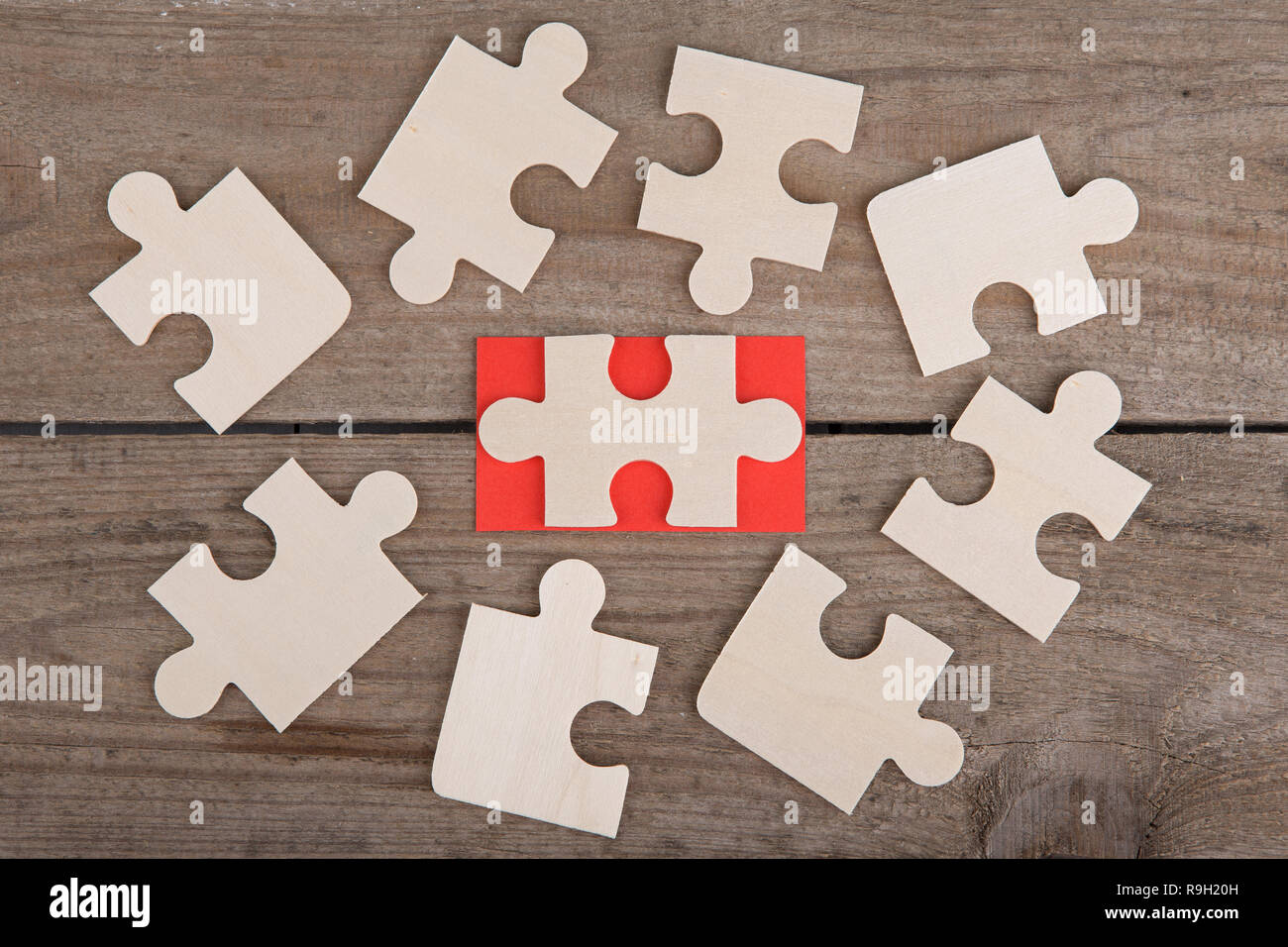 Business Teamwork Concept - Jigsaw Puzzle Pieces on wooden background Stock Photo