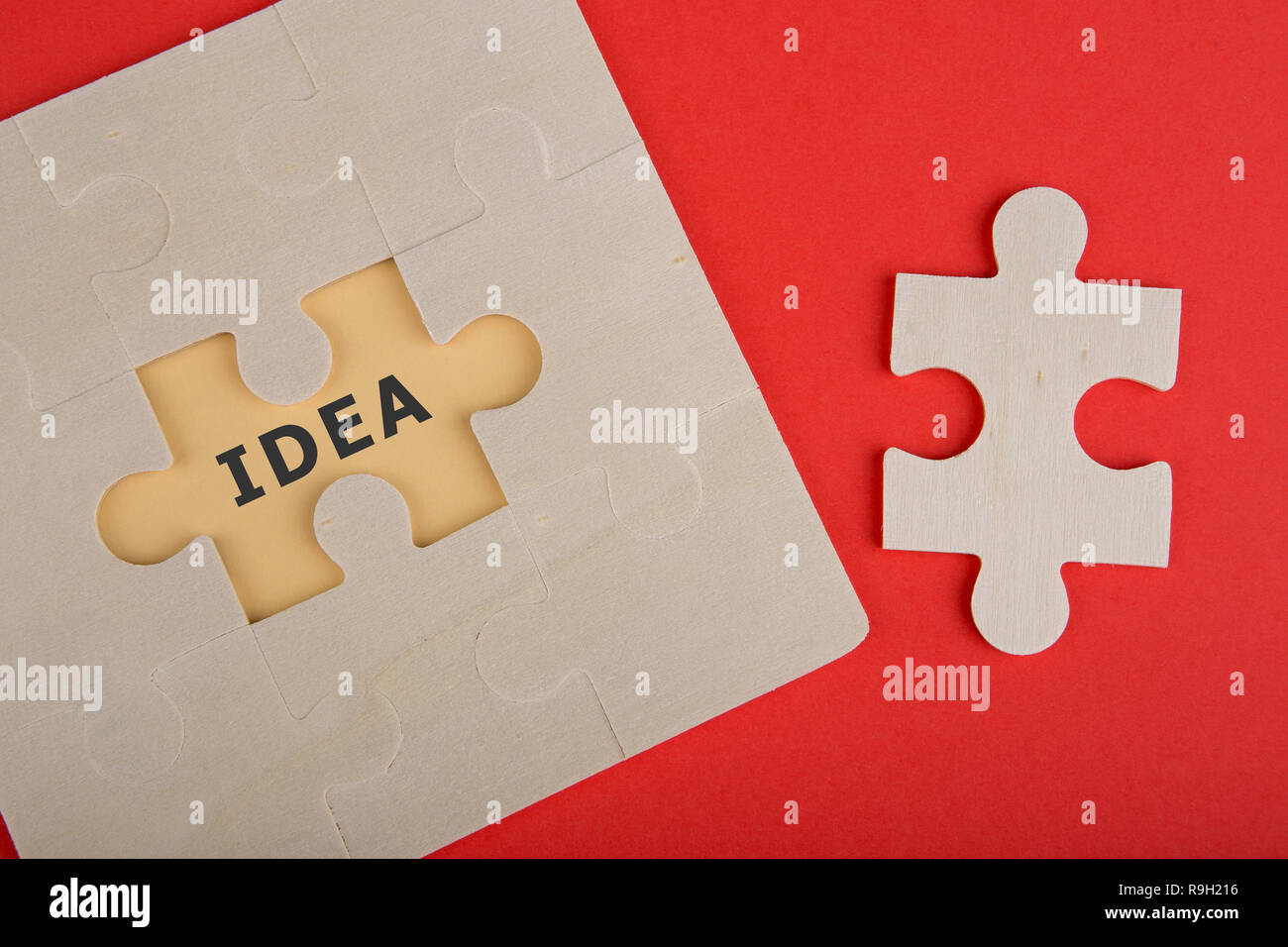 Business Teamwork Concept - Jigsaw Puzzle Pieces with text 'IDEA' on red background Stock Photo