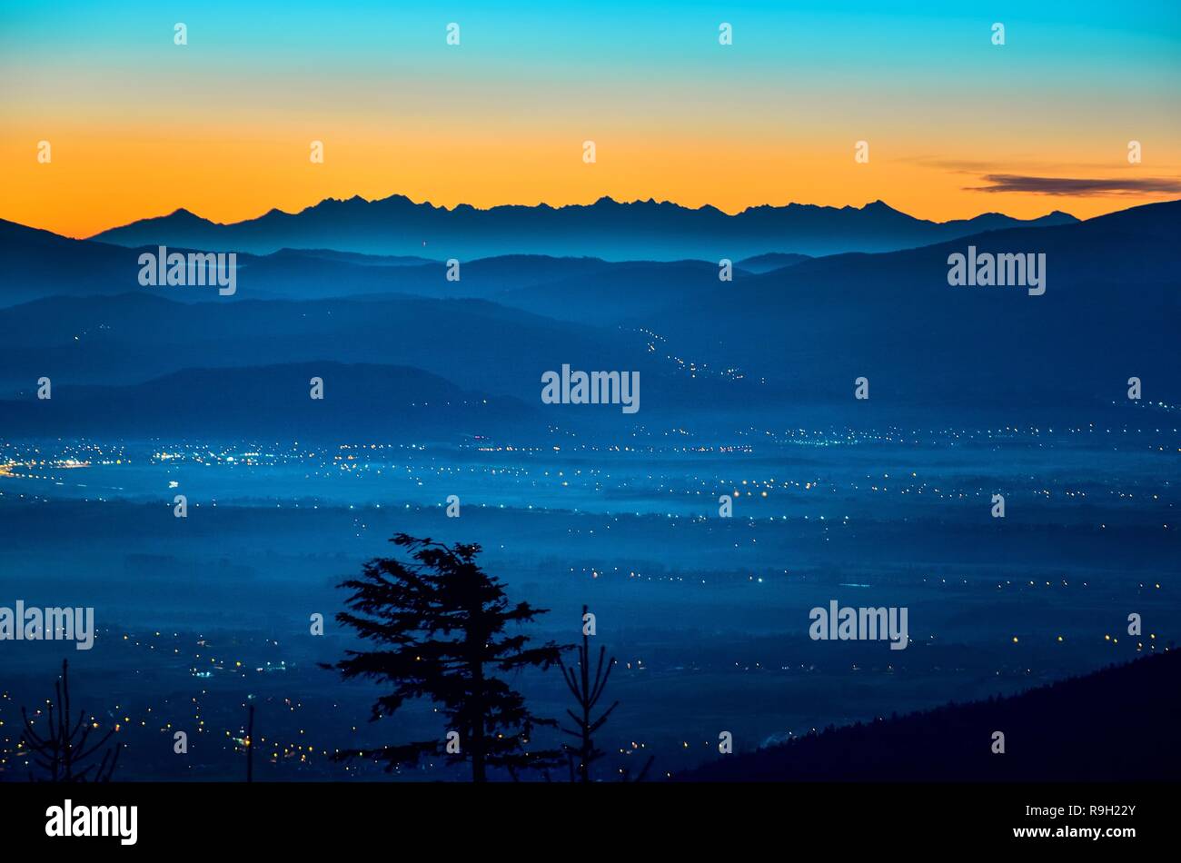 Beautiful morning autumnal mountain landscape. Interesting light over the mountain tops just before dawn. Stock Photo