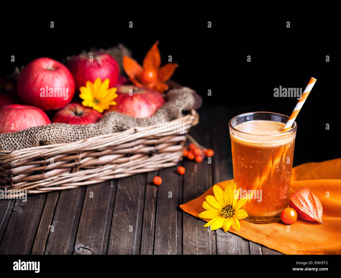 Fresh apple juice on wooden background in autumn season Stock Photo