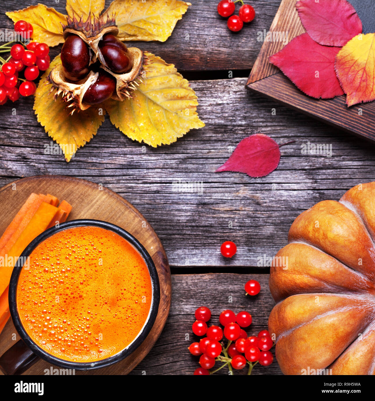 Fresh pumpkin and carrot juice on wooden background in autumn season Stock Photo