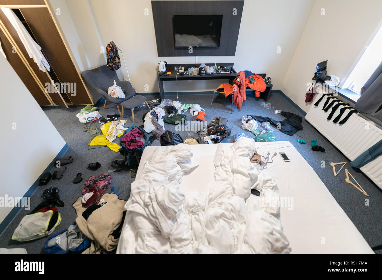 Super messy hotel room backpacking backpackers Stock Photo - Alamy