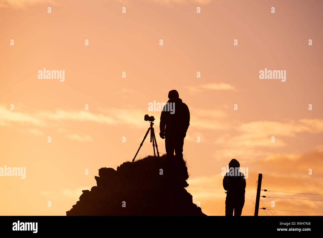 Two photographers taking pictures Iceland sunset Stock Photo