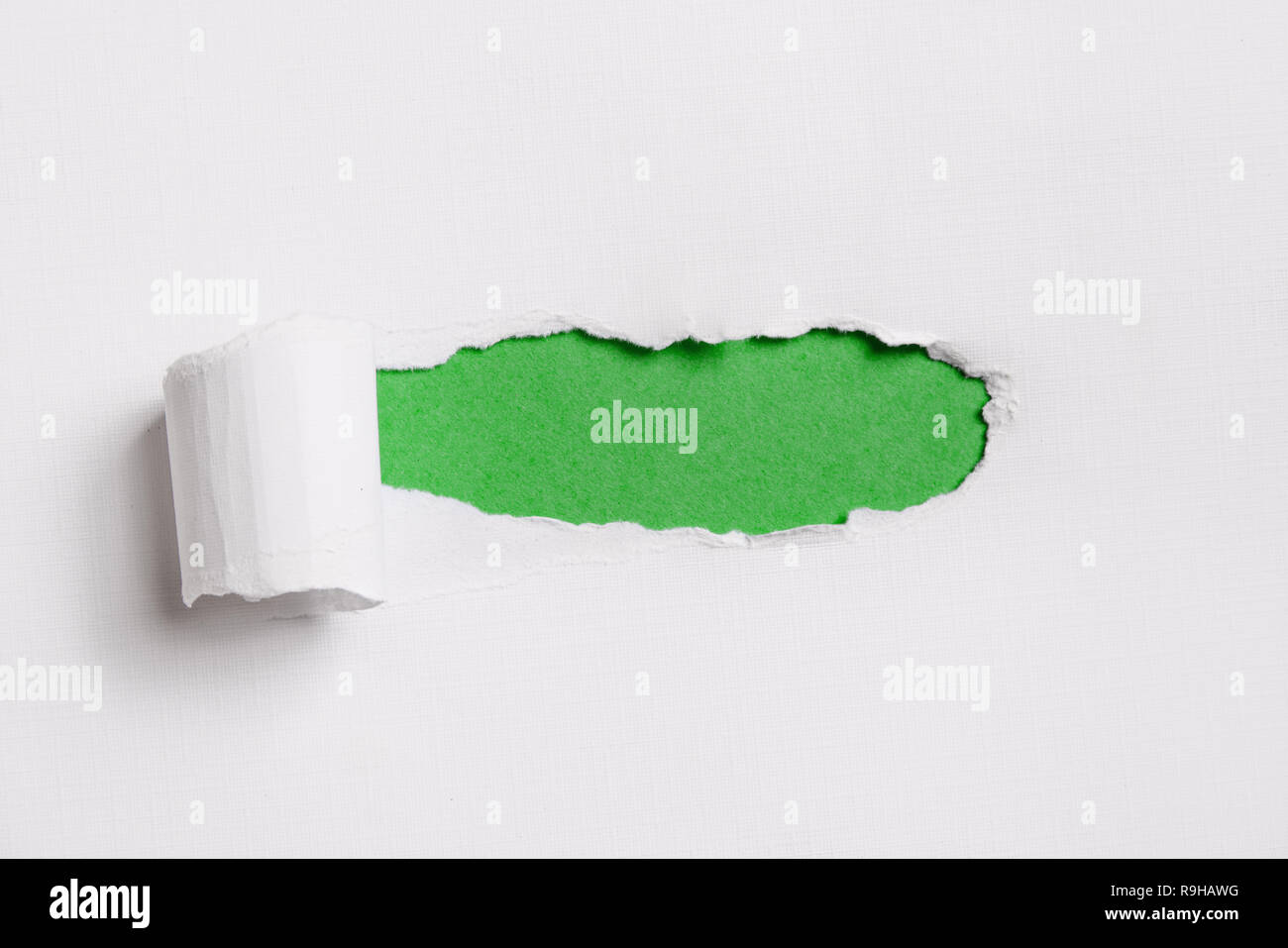 Torn white paper with green copy space for your text. Stock Photo