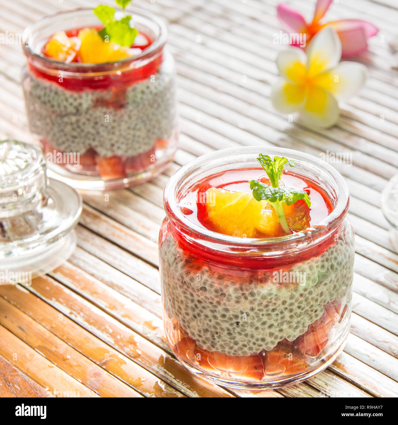 Chia seed and strawberry dessert in glass jar placed on table Stock Photo