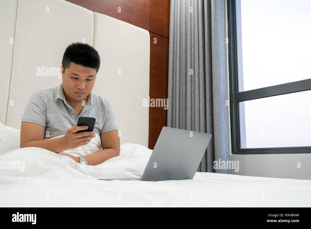 Young businessman checking emails on smart phone Stock Photo