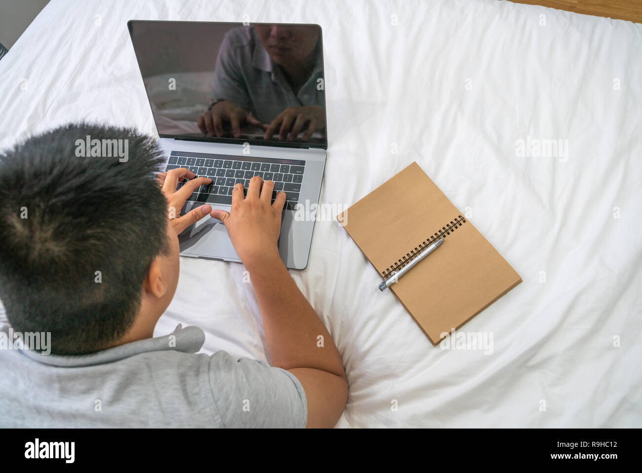 Overhead view of young man working on laptop Stock Photo