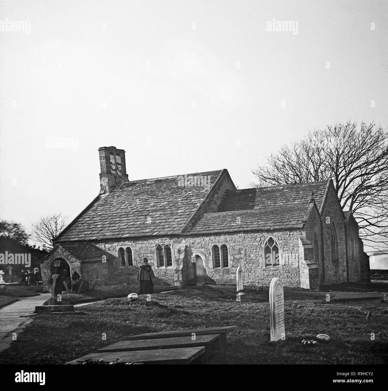 Early twentieth century black and white photograph showing St. Peter's Church in the village of Heysham in the county of Lancashire in England. It is believed that a church was founded on this site in the 7th or 8th century. In 1080 it was recorded that the location was the site of an old Saxon church. Some of the fabric of that church remains in the present church. The chancel was built around 1340–50 and the south aisle was added in the 15th century. The north aisle was added in 1864 and other extensions and restorations were carried out by the Lancaster architect E. G. Paley. Grade 1 listed Stock Photo