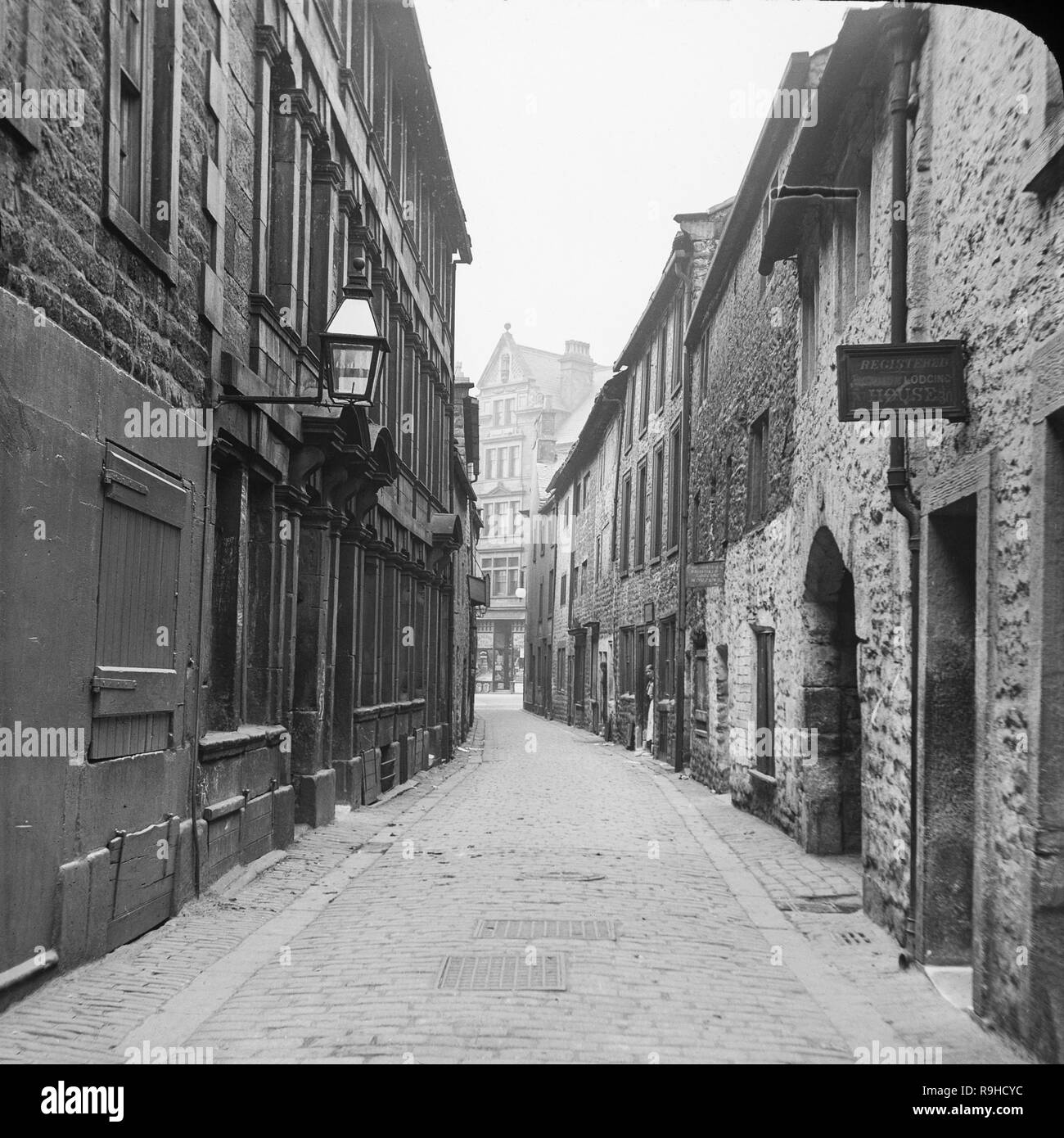 China Lane in Manchester, England. A late Victorian black and white photograph showing houses and buildings. There are two houses advertising as Boarding or Lodging houses, and two women can be seen standing in doorways. Stock Photo