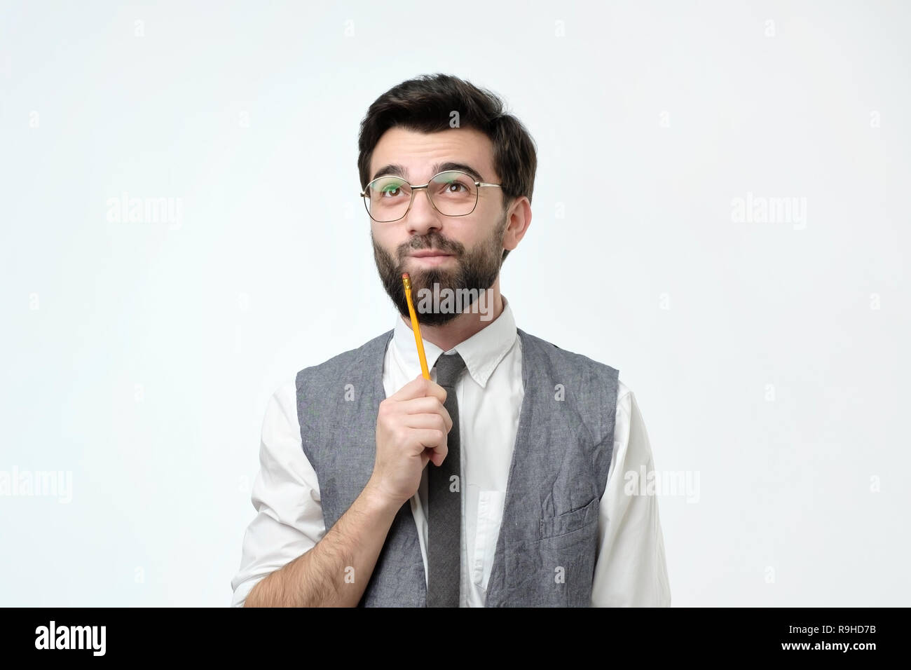 man is thinking about something with pencil Stock Photo