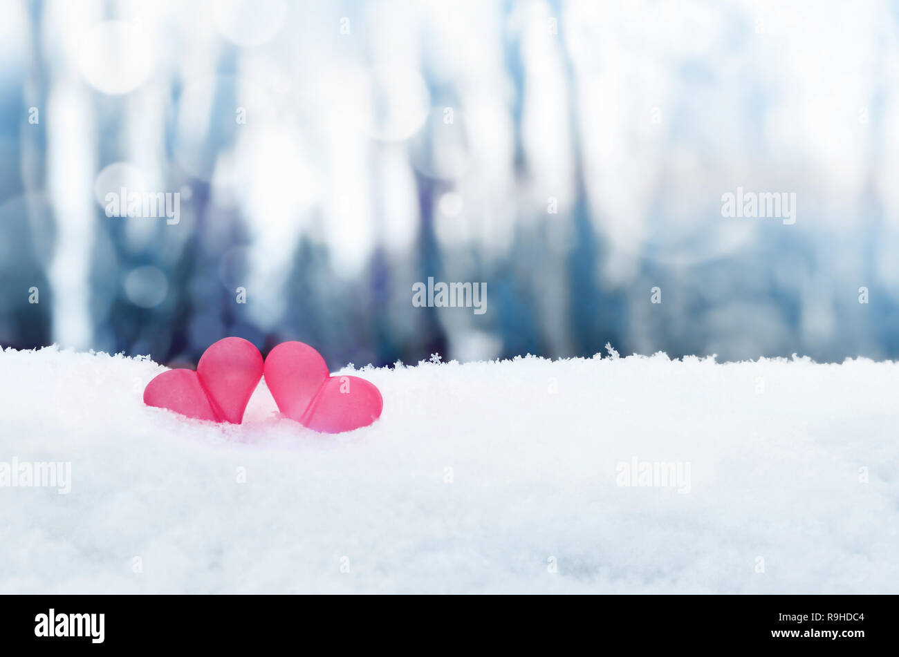 Beautiful romantic vintage red hearts together on white snow winter. Love and St. Valentines Day concept Stock Photo