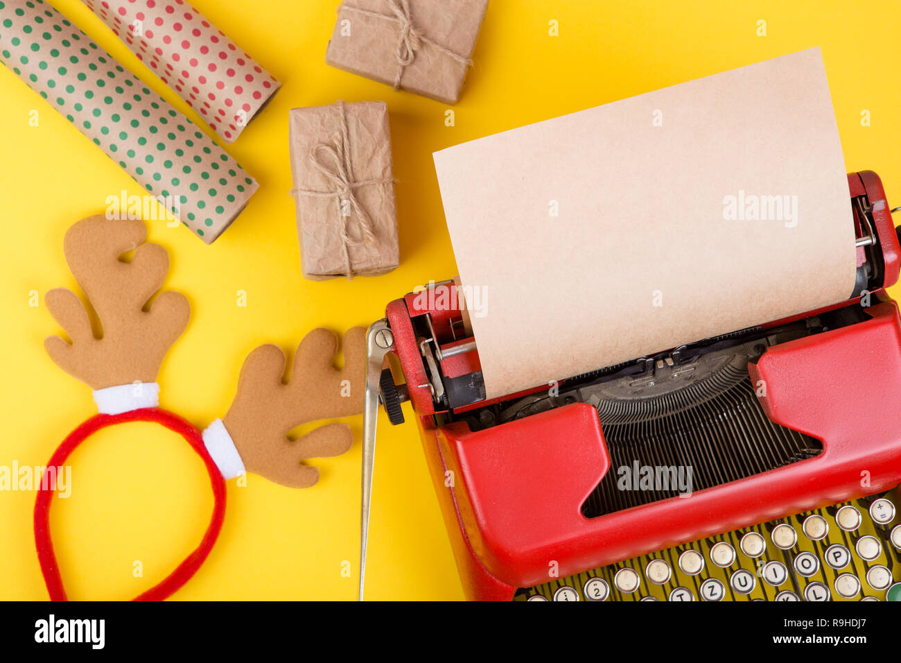 Holidays concept red typewriter with blank craft paper, gift boxes on