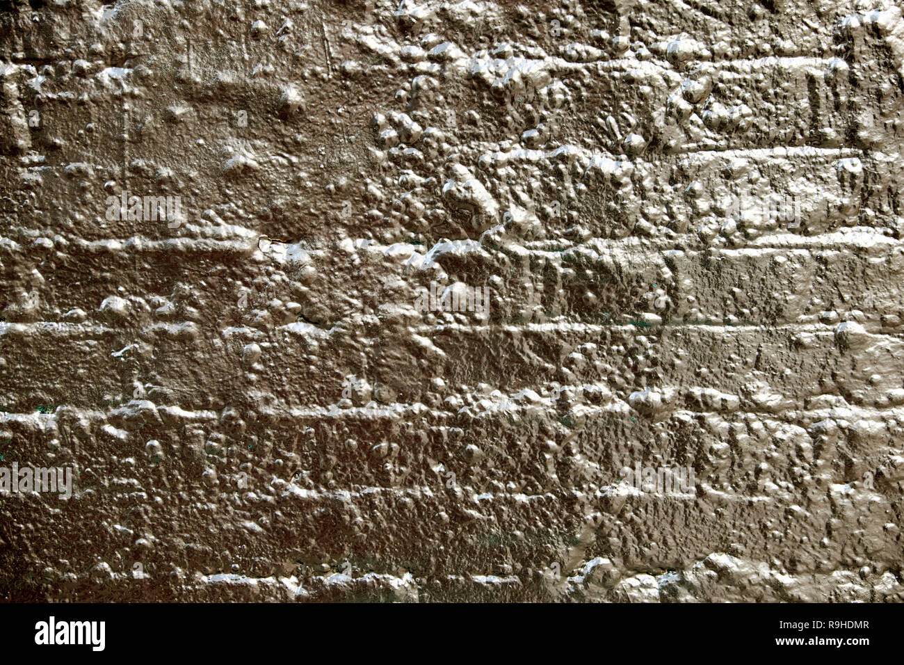 Brick wall painted with gold paint as a background for an advert in Hoxton London UK  KATHY DEWITT Stock Photo