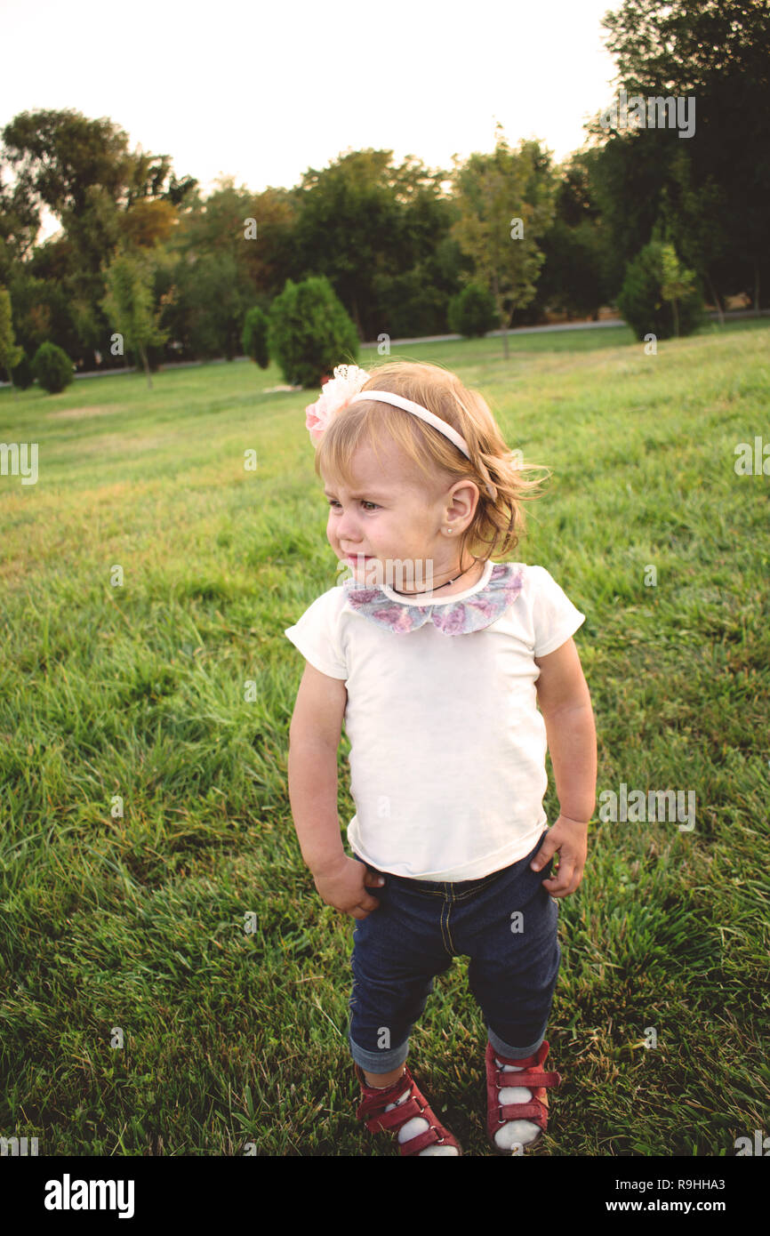 a very cute and red-haired upset little girl. frustrated and sullen child.  Baby girl Stock Photo - Alamy