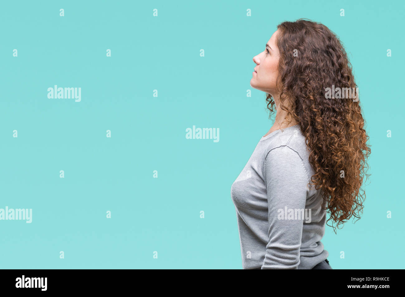 Beautiful Brunette Curly Hair Young Girl Wearing A Sweater Over