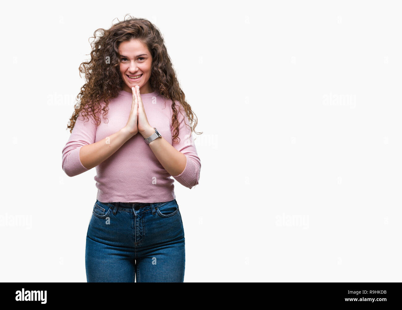 Beautiful brunette curly hair young girl wearing pink sweater over ...