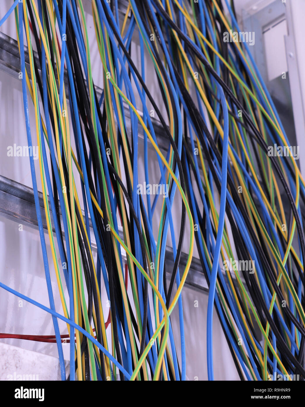 different colorful cables on the wall Stock Photo