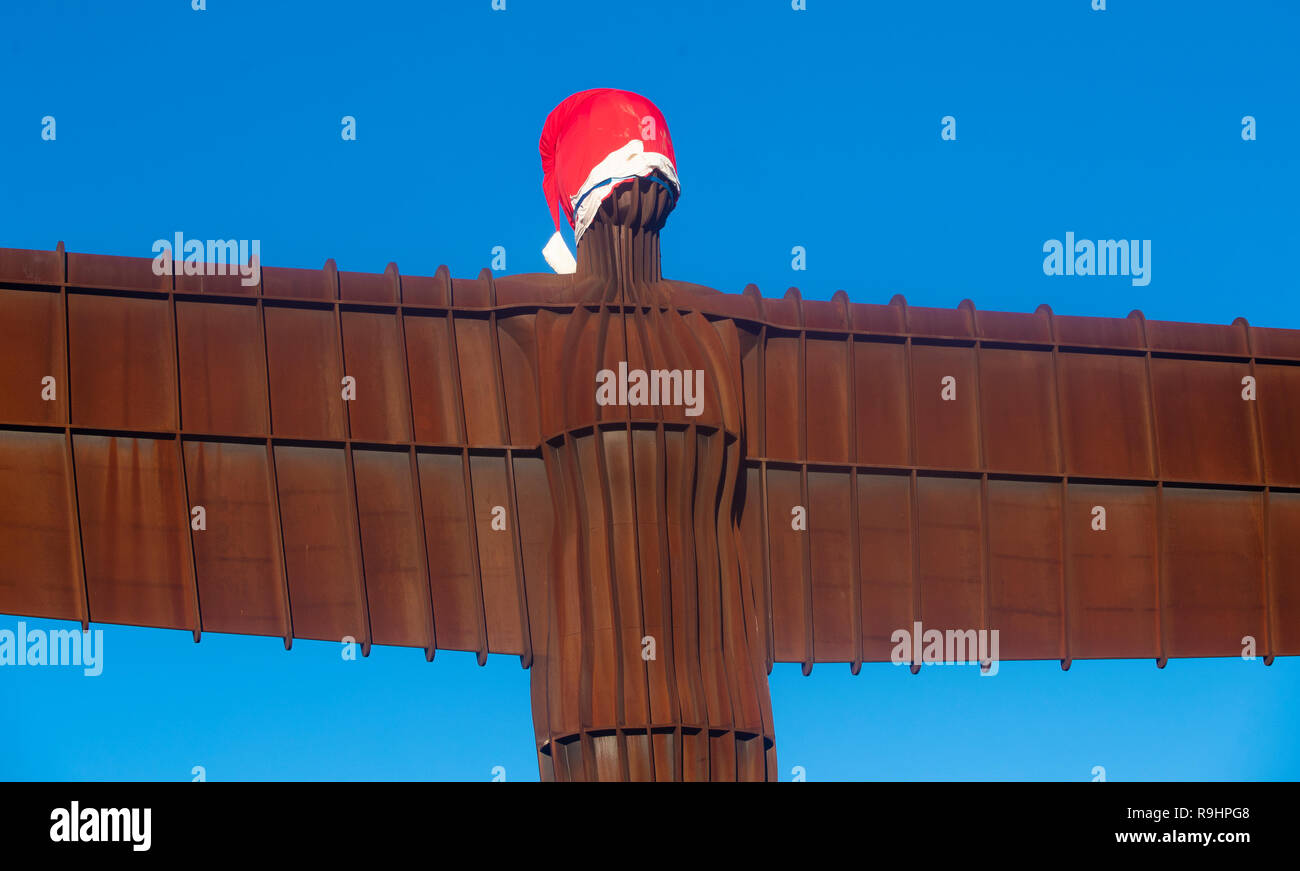 A Santa hat on the 20 metres tall steel sculpture 'Angel of the North', outside Gateshead, Tyne and Wear, in NE Engand. Stock Photo
