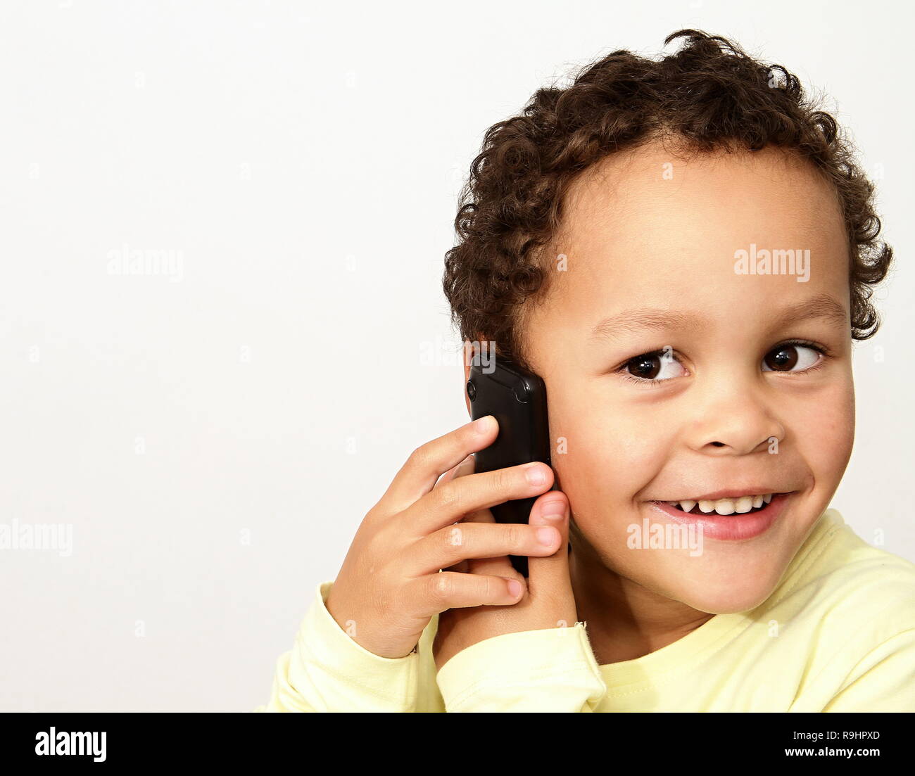 little boy with mobile making a phone call stock photo Stock Photo