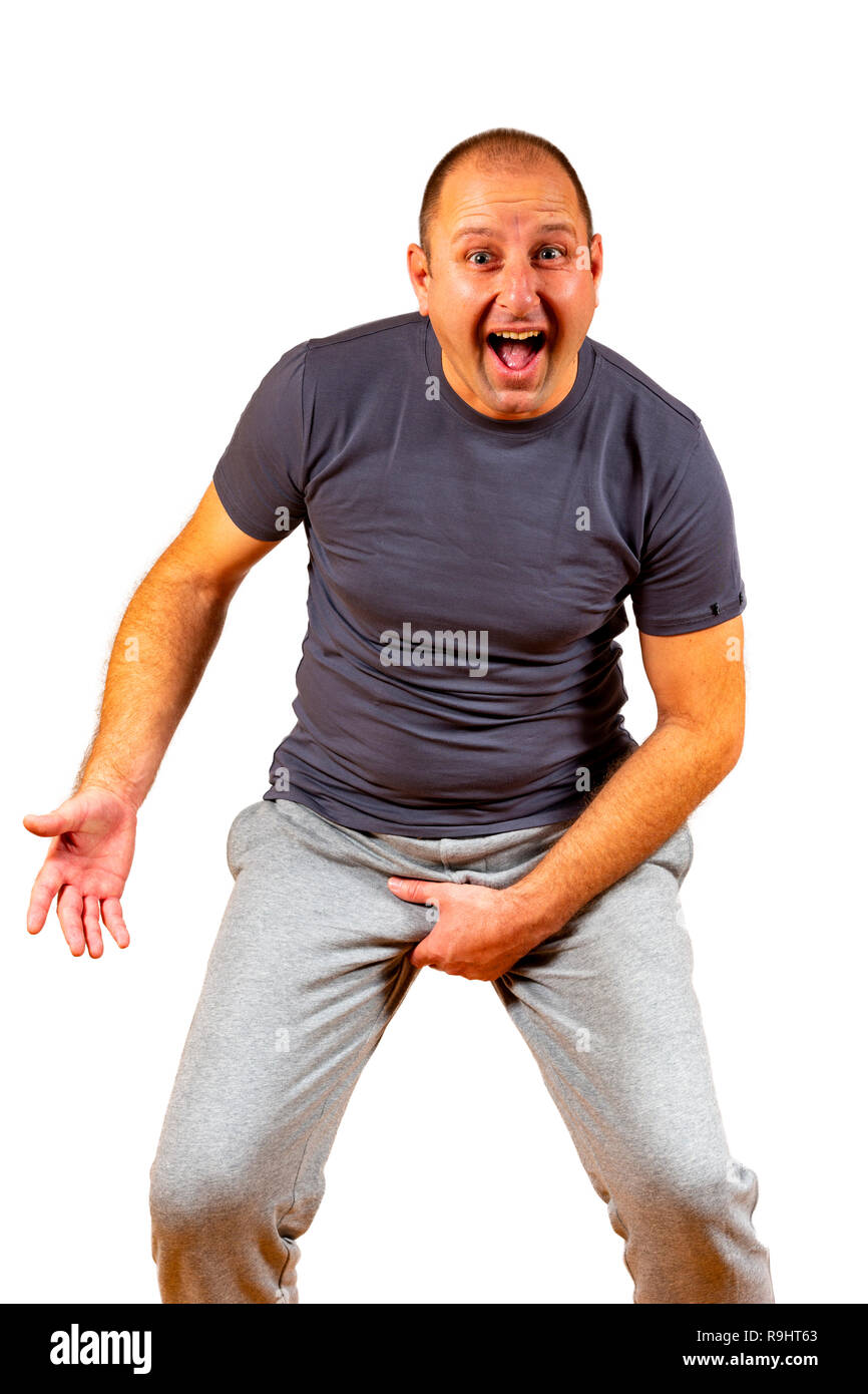 Isolated shot of a white middle aged male grabbing his genitalia. Stock Photo