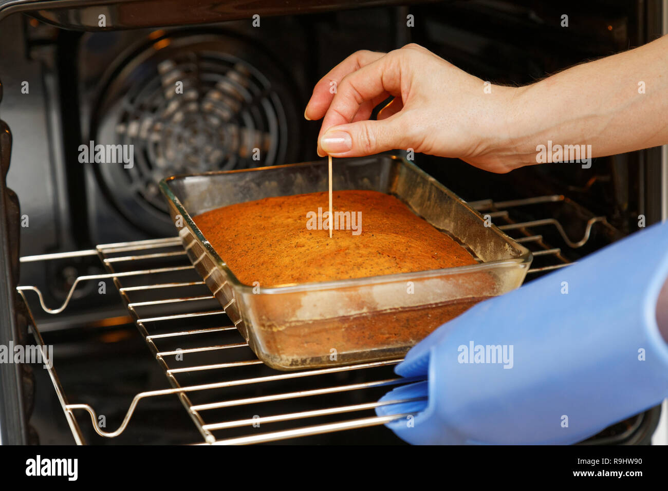 Bake in an open oven. Cook checks readiness cake Stock Photo Alamy