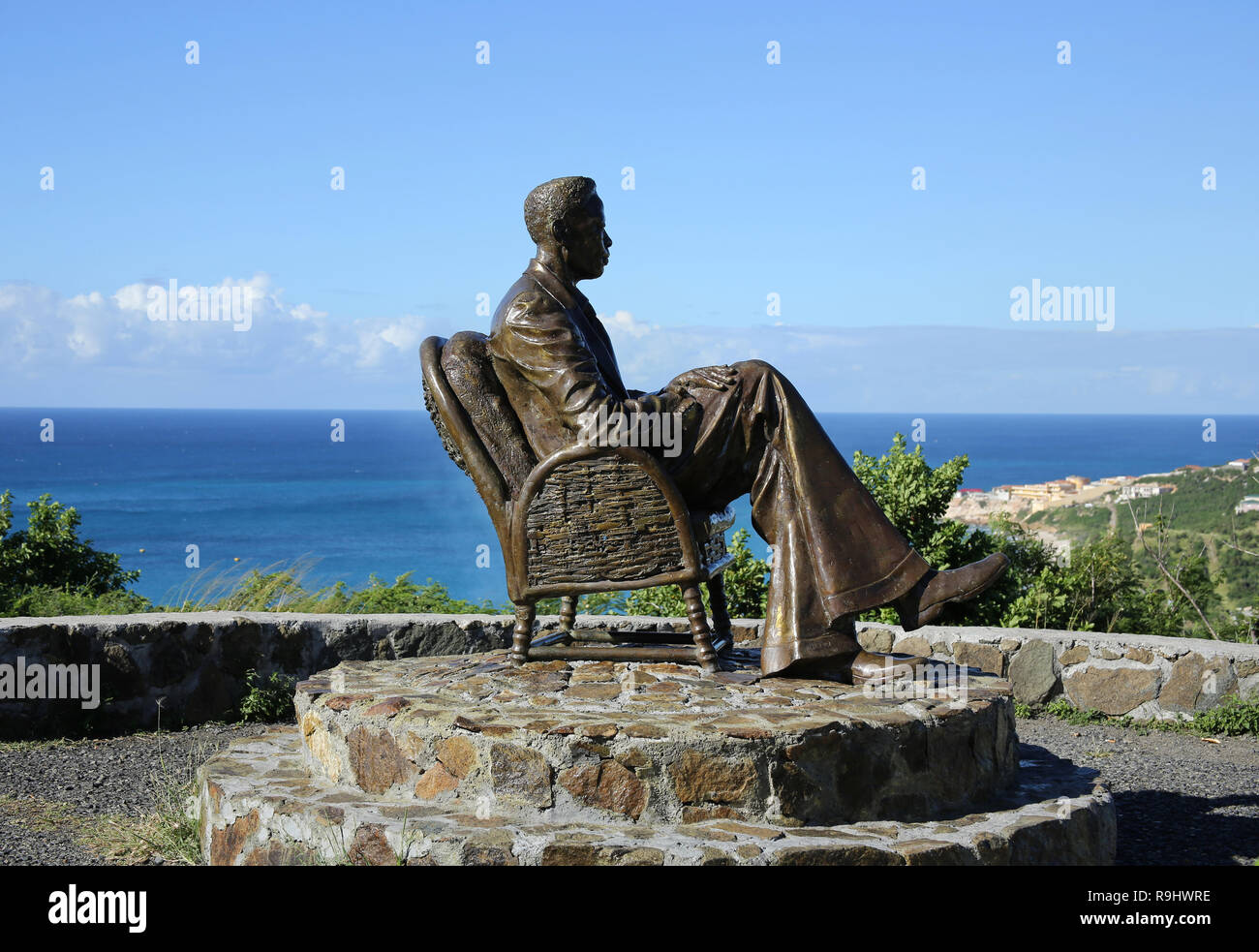 The statue of the lone figure on top of Cole Bay Hill on the Caribbean island of Sint Maarten taking in the view across the landscape towards Anguilla. Stock Photo