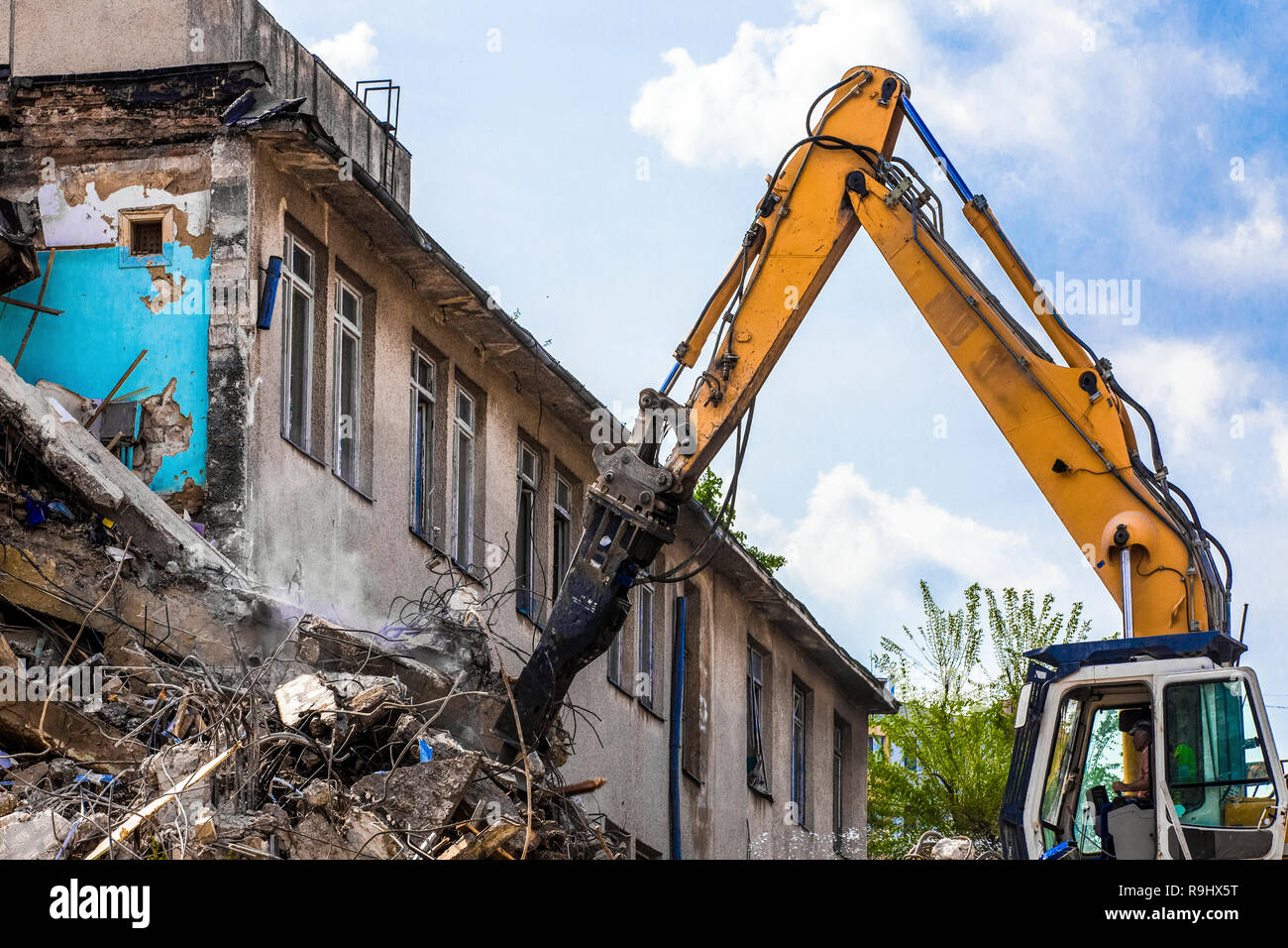 demolition of a building with a hydraulic excavator Stock Photo - Alamy