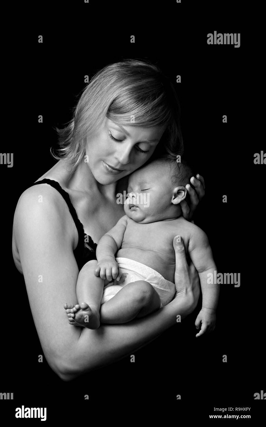 baby with mother after having a good sleep in bed at homestock photo Stock Photo