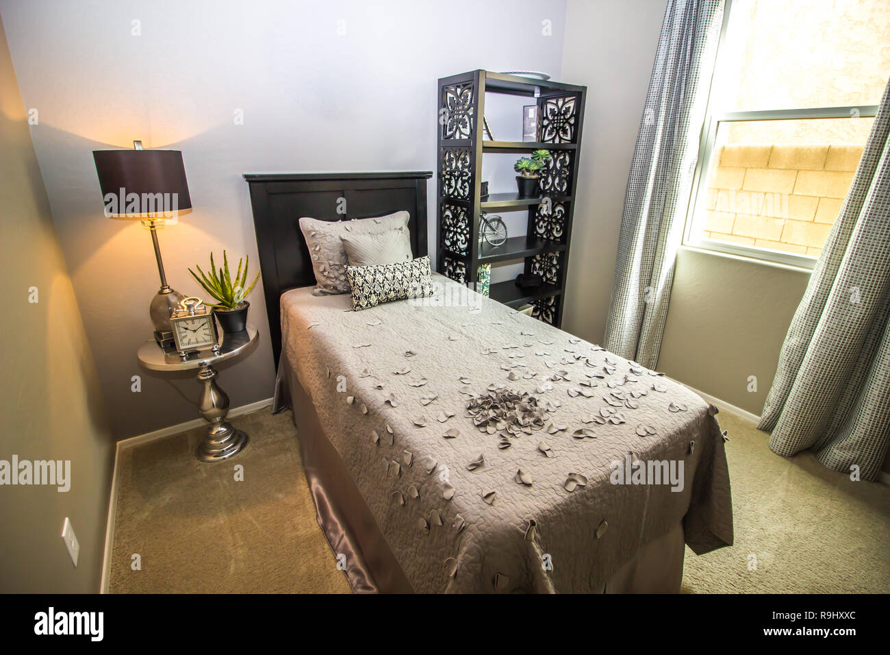 Twin Bed With Pedestal Table, Lamp And Bookcase Stock Photo