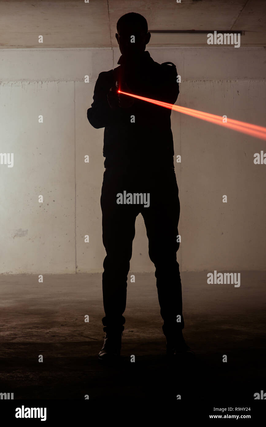 Shape of a assassin man who is holding laser gun in his hands Stock ...