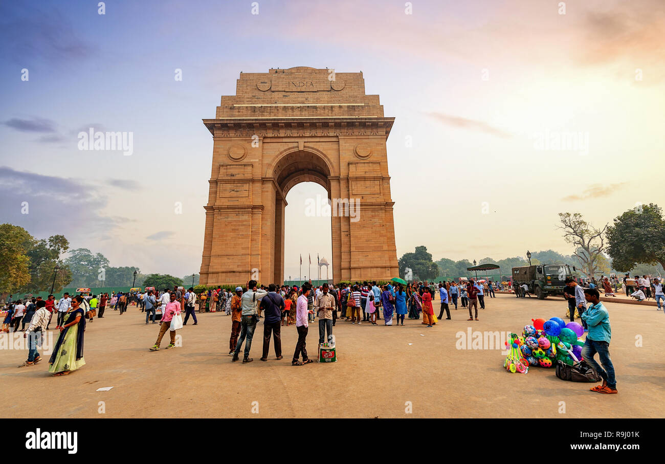 Tourists enjoy near India Gate historic war memorial Delhi at sunset. Stock Photo