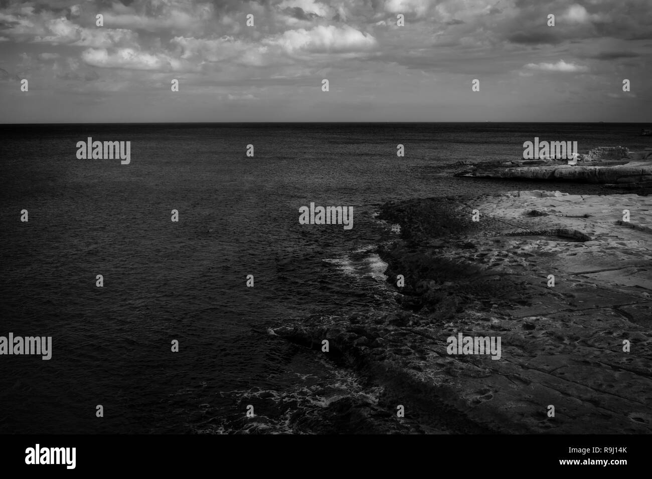 The Beach in Malta in black and white featuring the rocks, shoreline