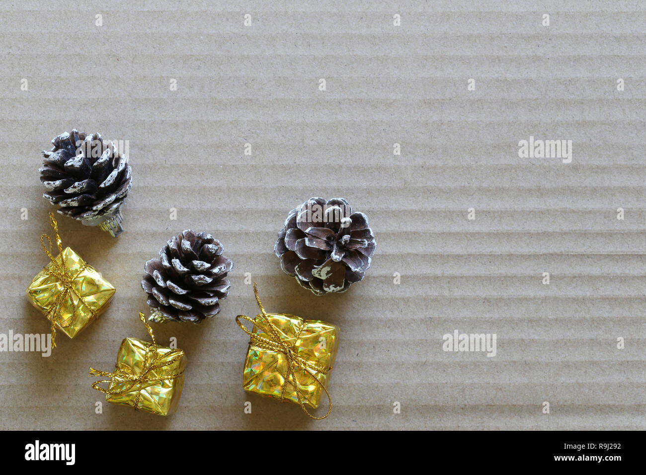 Gold gift boxes and Pine cones on brown hard paper for Christmas ...