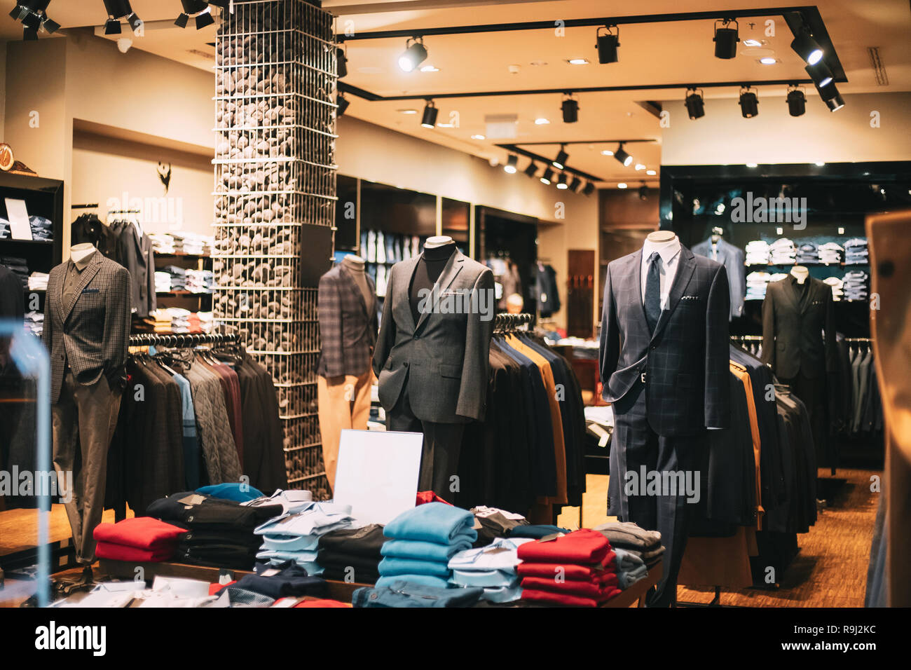 Male Business Style Clothing. Male Clothes On Mannequins And Hangers In Store Of Shopping Mall. Stock Photo