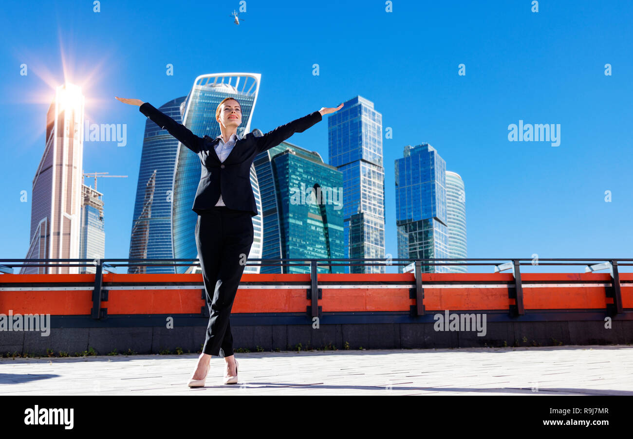 Business woman feels triumph on observation deck Stock Photo